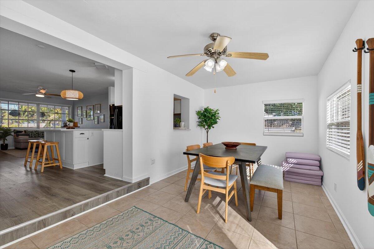 110 Northeast 30th Street Pompano Beach, FL 33064 - Photo 10 of 31 a dining room with wooden floor and a chandelier