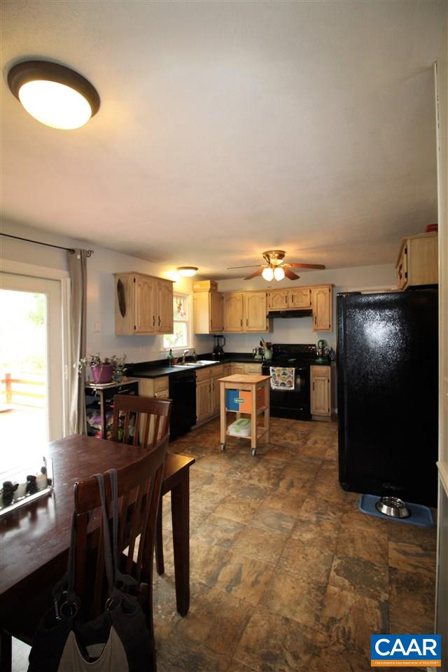 896 Cedar Grove Road Ruckersville, VA 22968 - Photo 8 of 31 a kitchen with kitchen island a dining table and chairs