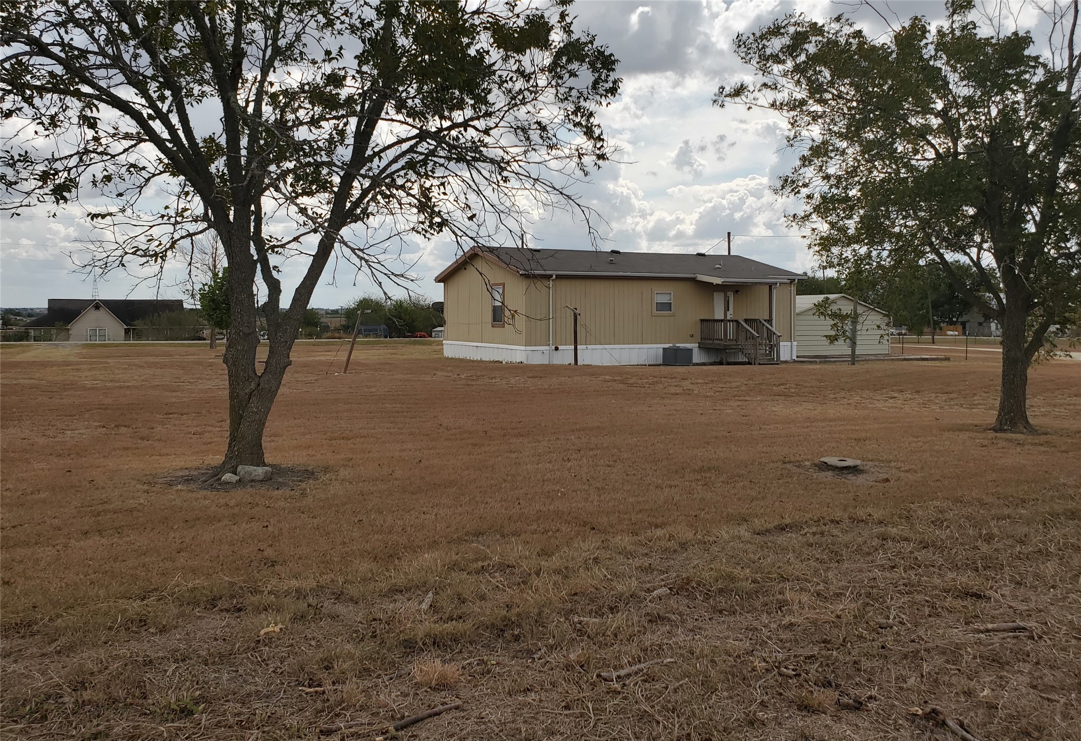 61 County Road 433 Taylor, TX 76574 - Photo 15 of 18 a view of a house with a tree