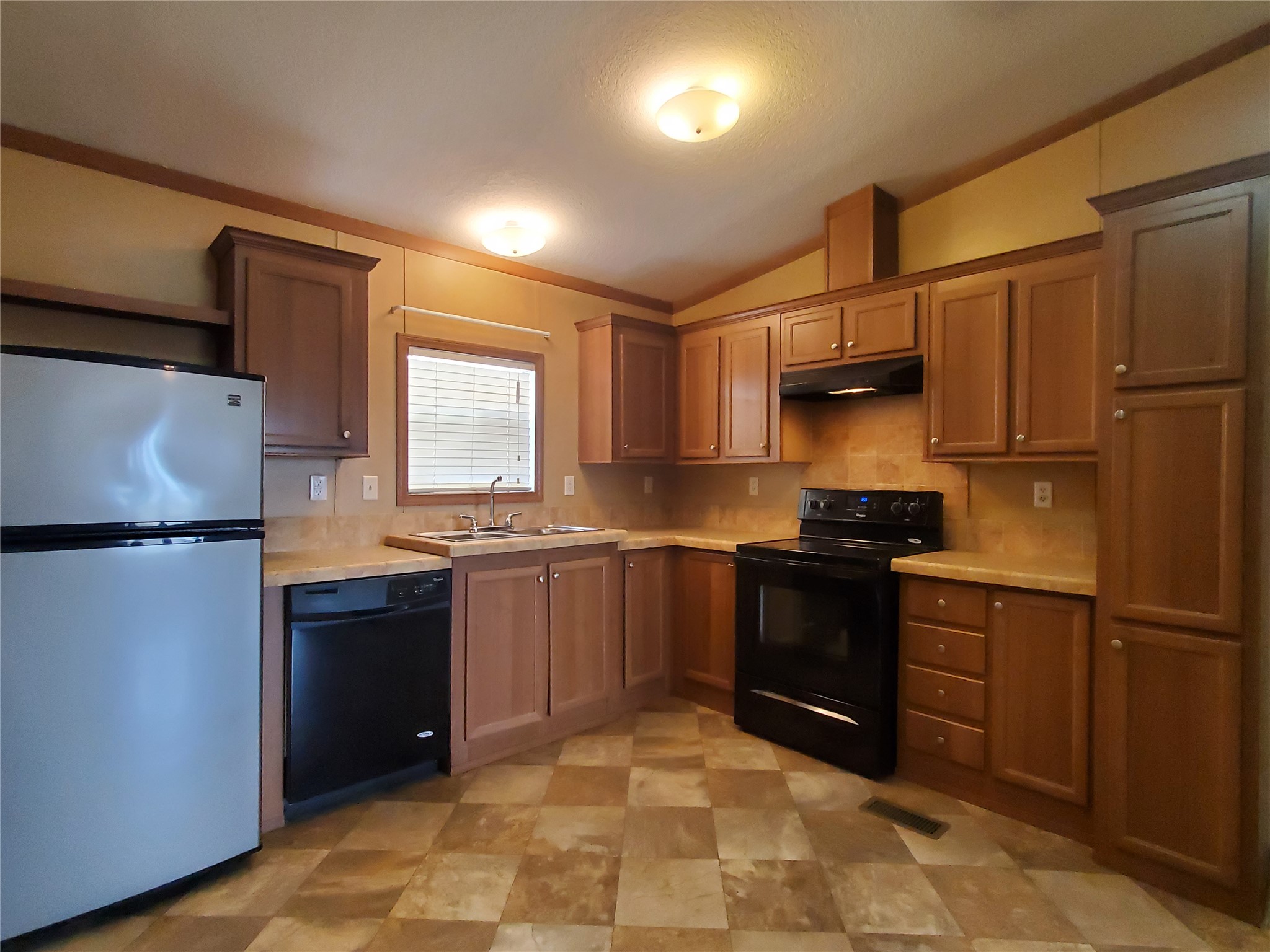 61 County Road 433 Taylor, TX 76574 - Photo 6 of 18 a kitchen with stainless steel appliances granite countertop a refrigerator sink and stove
