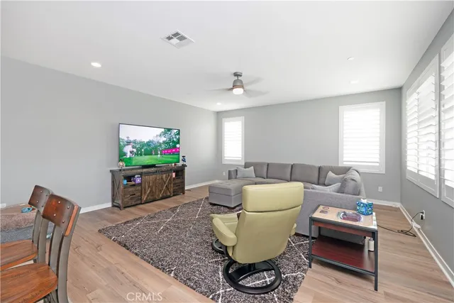 a kitchen with stainless steel appliances kitchen island granite countertop a dining table chairs and granite counter tops