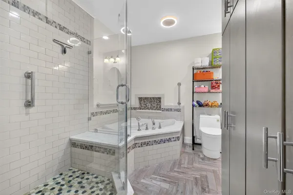 a bathroom with a sink a toilet and shower