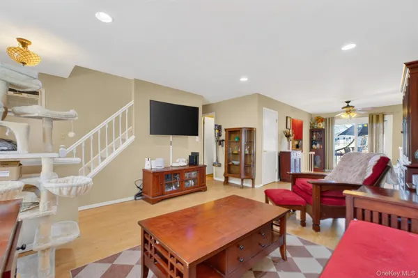 a living room with furniture a rug and a flat screen tv