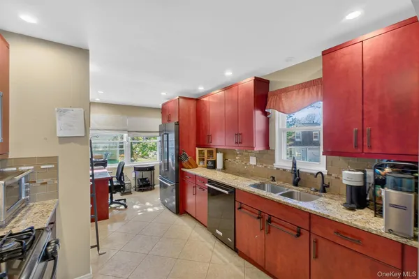 a kitchen with stainless steel appliances a sink stove and a refrigerator