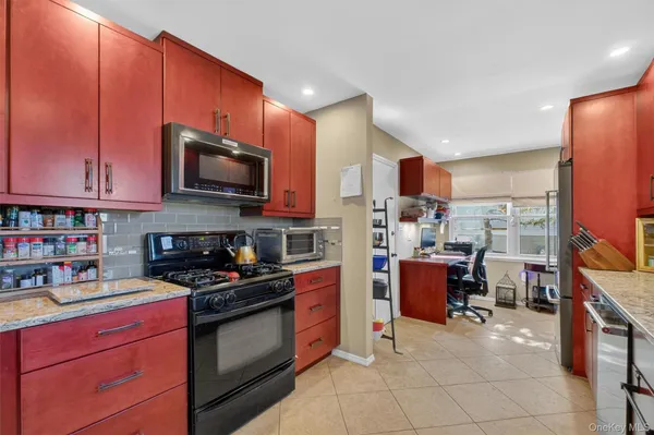 a kitchen with stainless steel appliances a stove sink microwave and cabinets