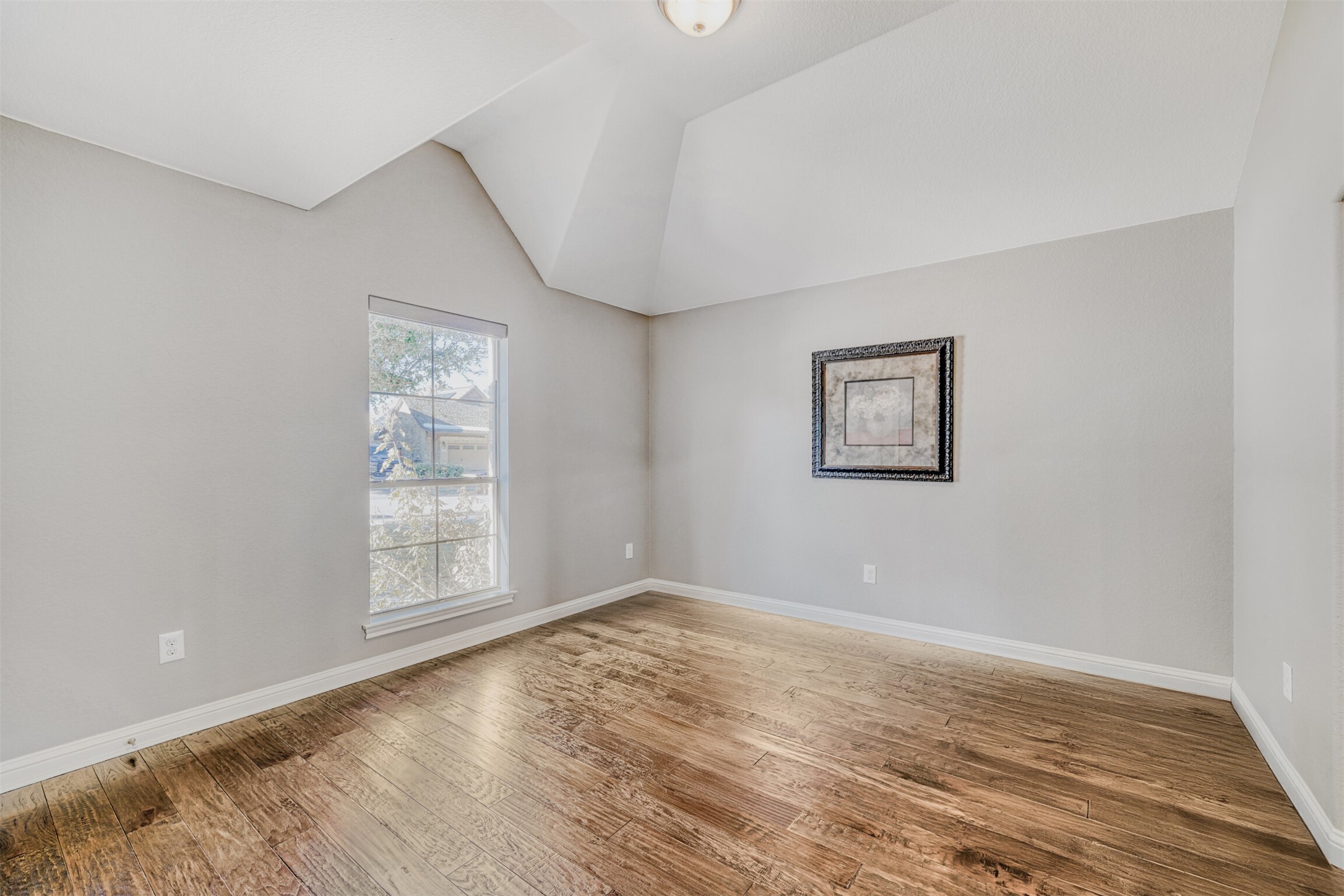 2431 Santa Barbara Loop Round Rock, TX 78665 - Photo 15 of 34 Empty room with light wood-style flooring and vaulted ceiling