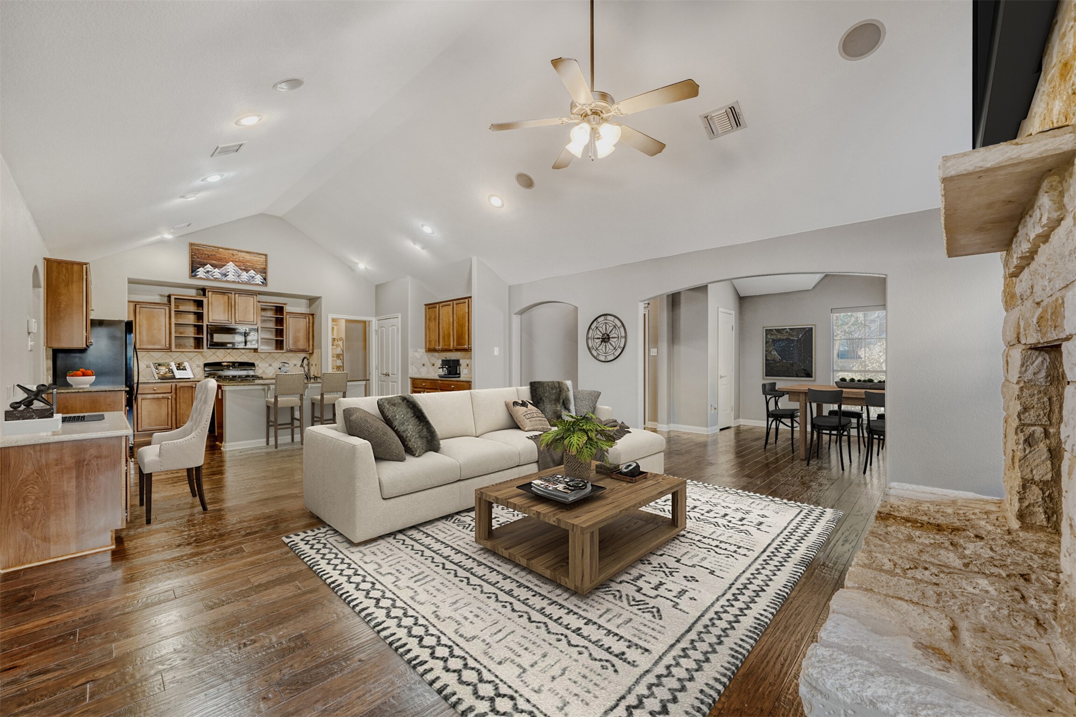 2431 Santa Barbara Loop Round Rock, TX 78665 - Photo 7 of 34 Living area with dark wood finished floors, ceiling fan, high vaulted ceiling, and arched walkways