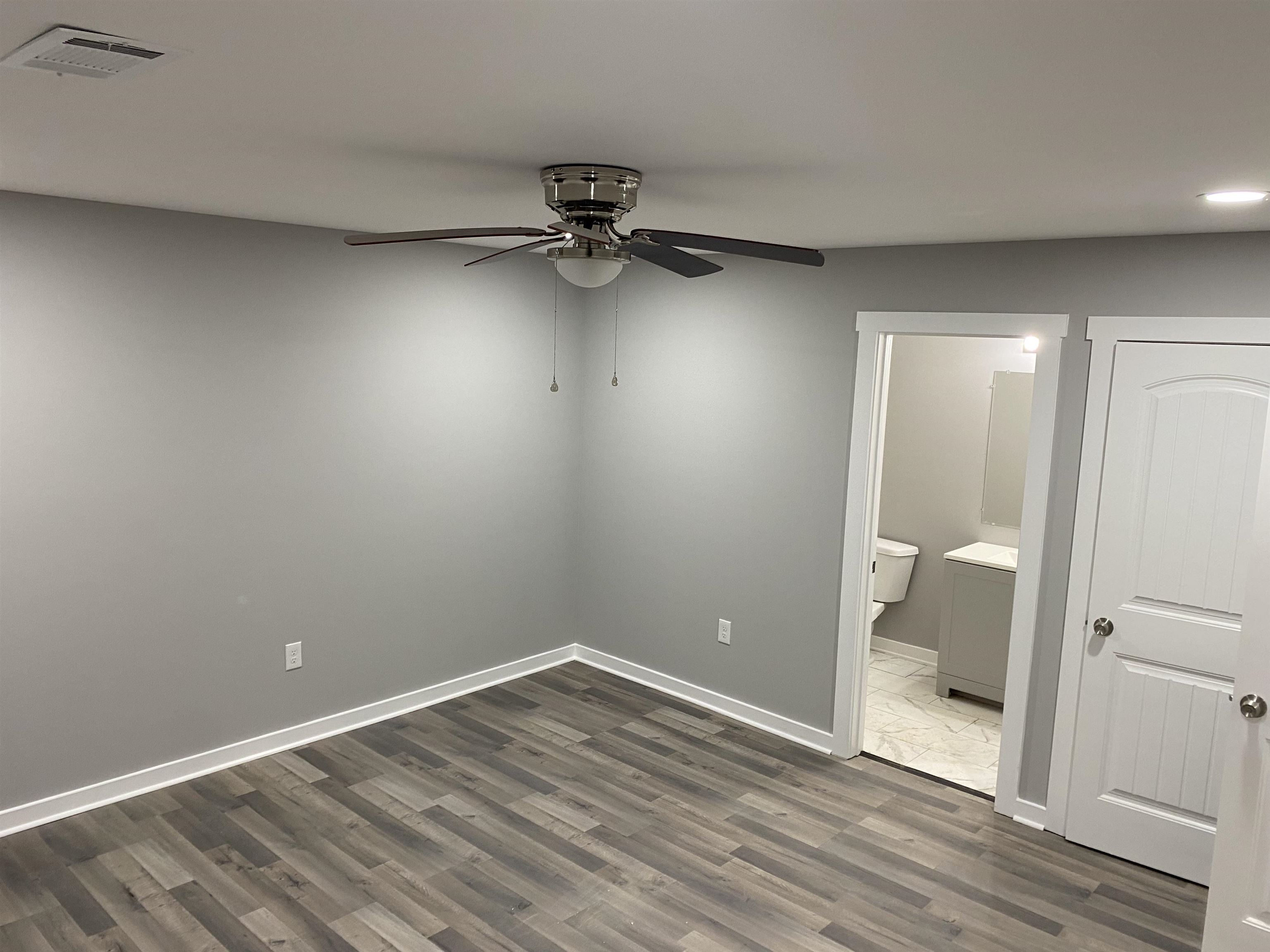 2352 Manchester Road Memphis, TN 38114 - Photo 11 of 36 a view of a room with wooden floor and white walls