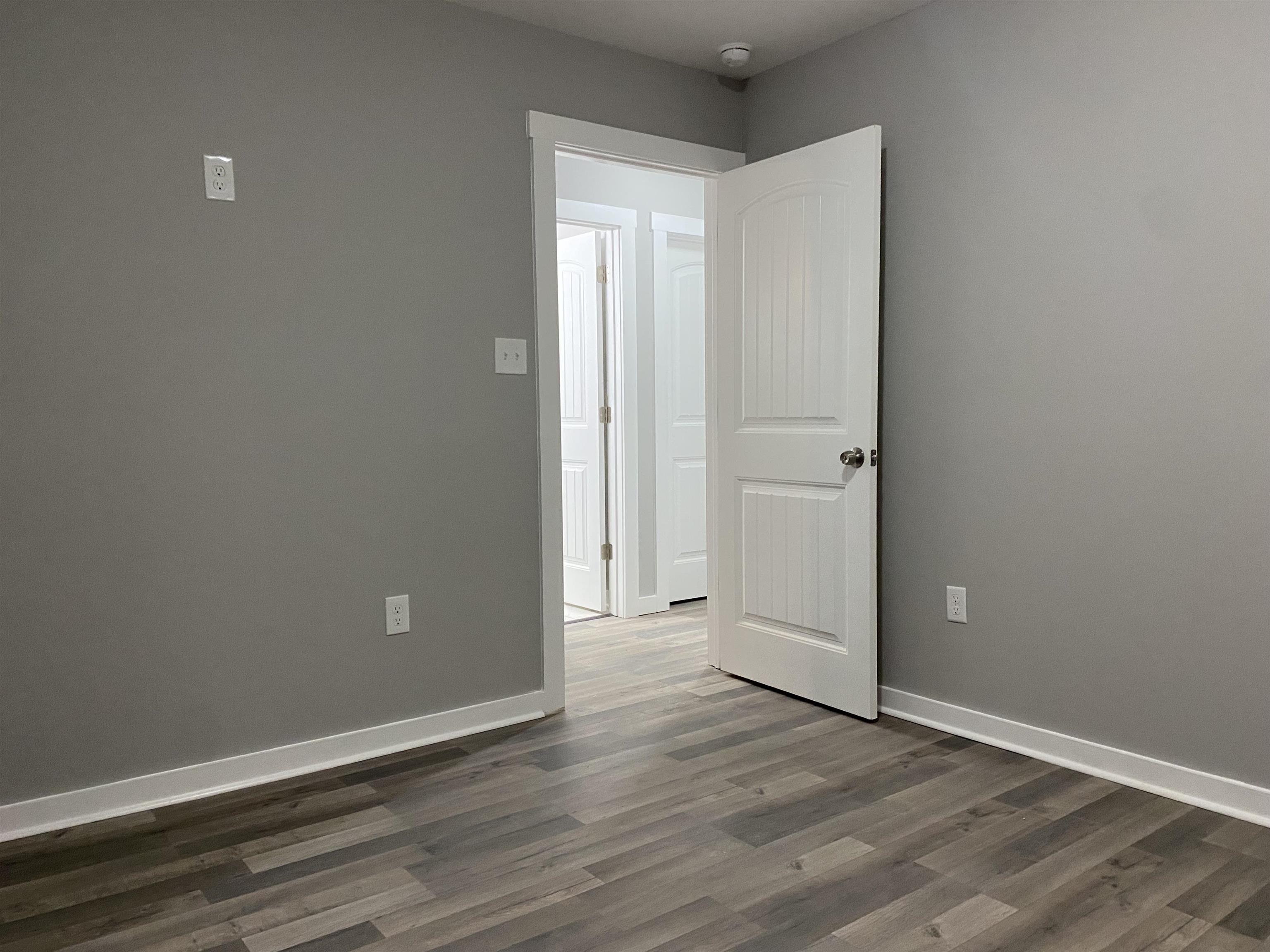 2352 Manchester Road Memphis, TN 38114 - Photo 19 of 36 an empty room with wooden floor and closet