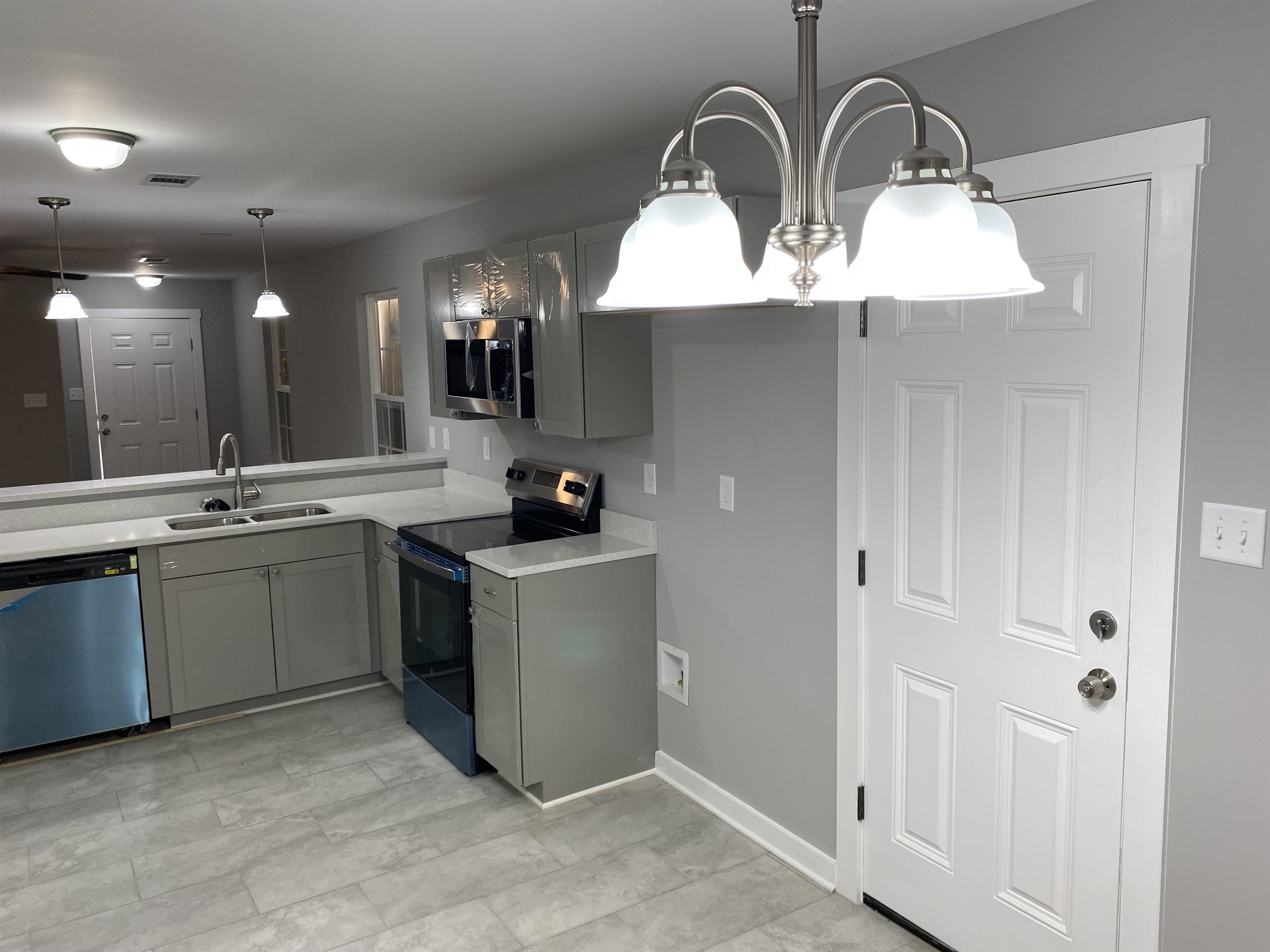 2352 Manchester Road Memphis, TN 38114 - Photo 27 of 36 a kitchen with stainless steel appliances a sink a stove and cabinets