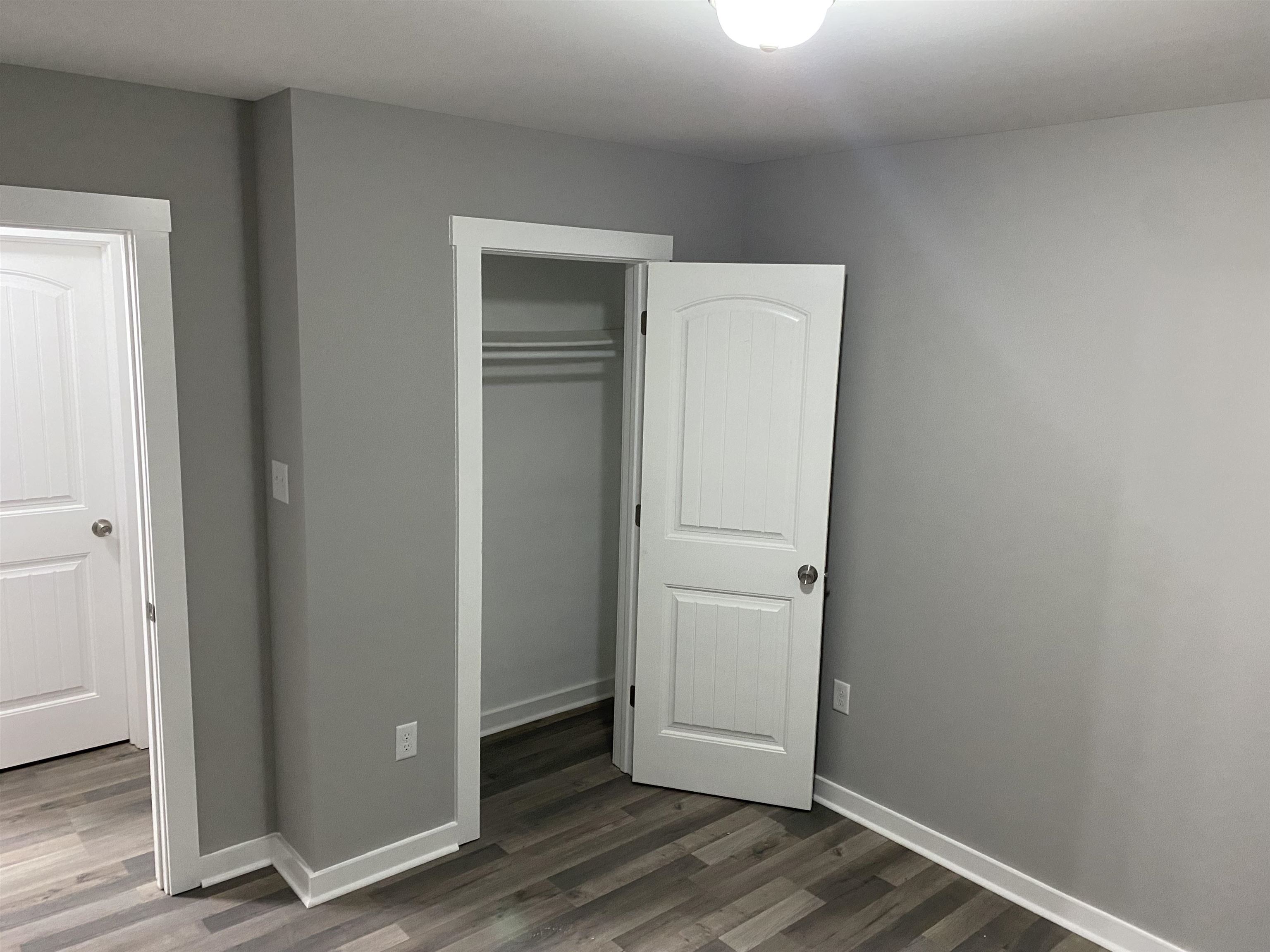 2352 Manchester Road Memphis, TN 38114 - Photo 35 of 36 an empty room with wooden floor and closet