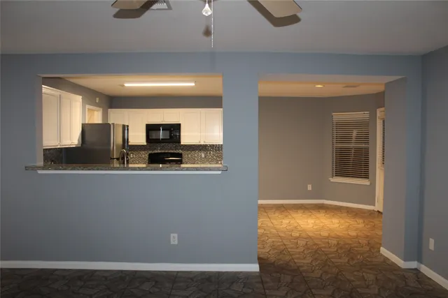 a view of kitchen with microwave and cabinets