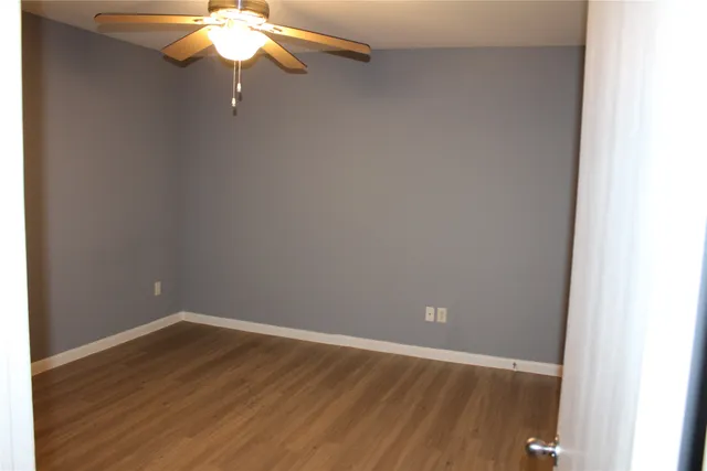 a view of a small space with wooden floor and chandelier