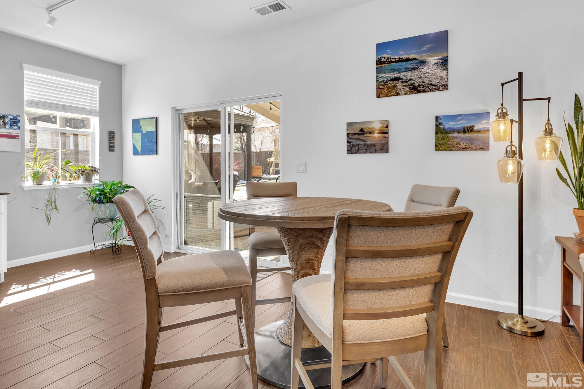 596 Needles Court Reno, NV 89521 - Photo 12 of 40 a dining room with furniture and wooden floor