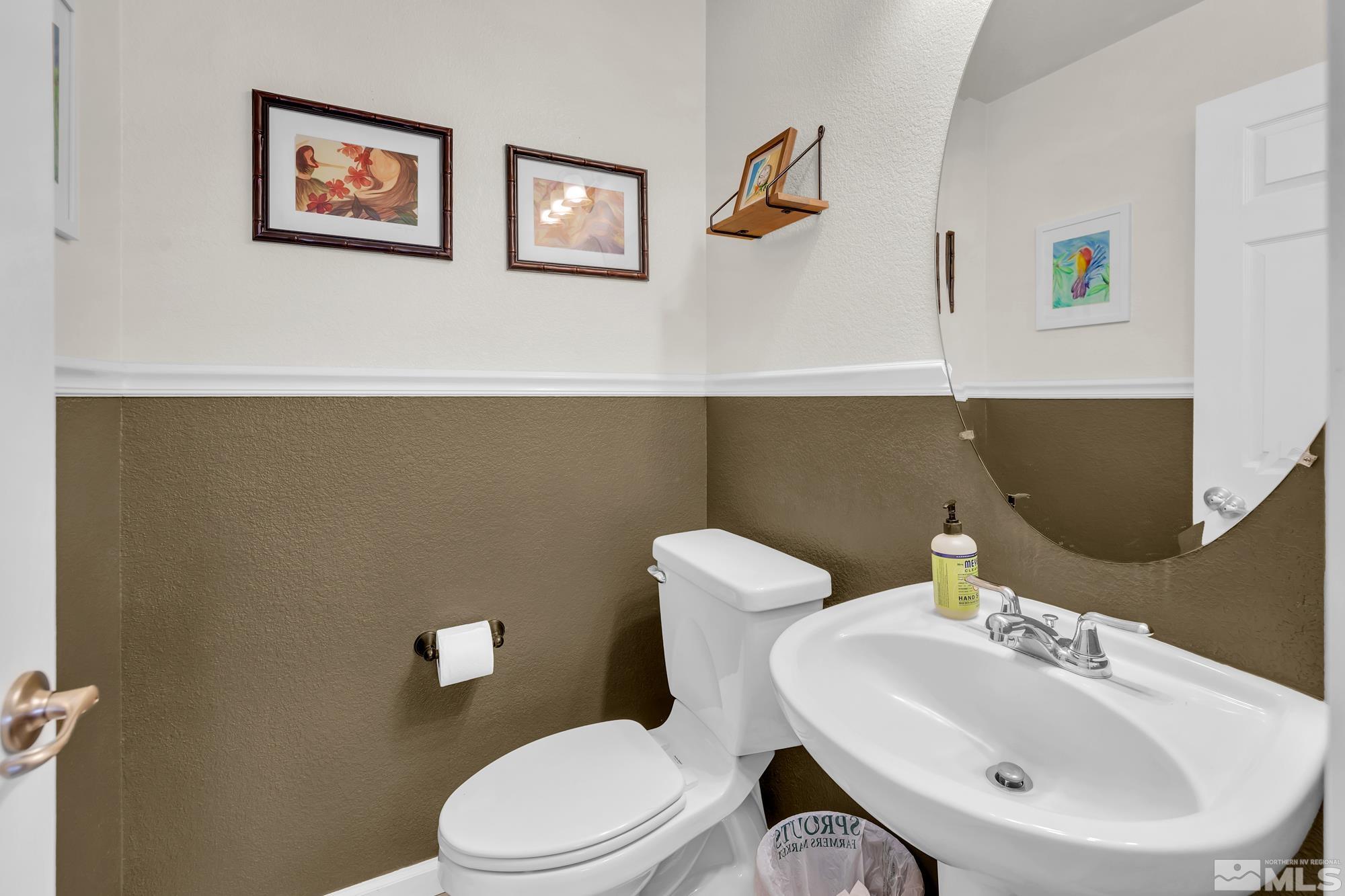 596 Needles Court Reno, NV 89521 - Photo 18 of 40 a bathroom with a toilet a sink and mirror