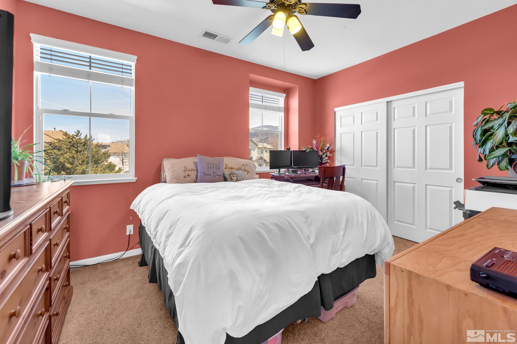 596 Needles Court Reno, NV 89521 - Photo 25 of 40 a bedroom with a bed and a chandelier