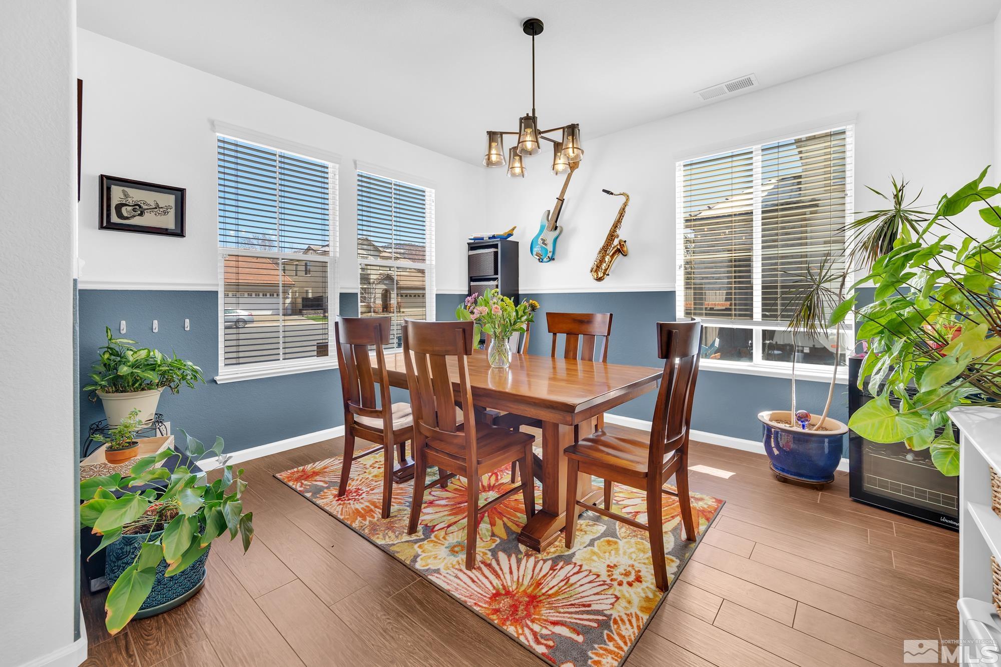 596 Needles Court Reno, NV 89521 - Photo 3 of 40 a view of a dining room with furniture window and wooden floor