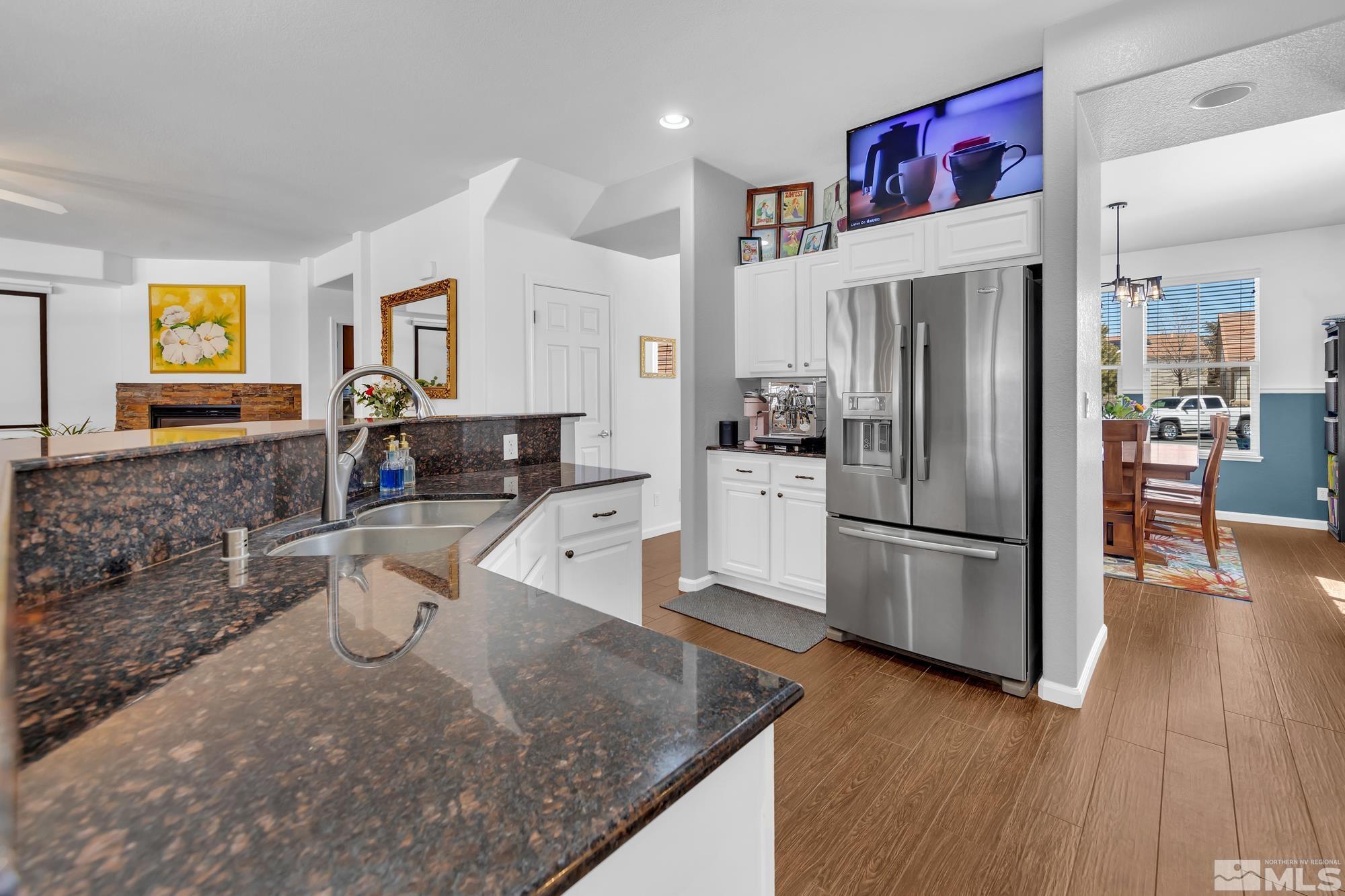 596 Needles Court Reno, NV 89521 - Photo 7 of 40 a kitchen with stainless steel appliances granite countertop a refrigerator a stove and a refrigerator