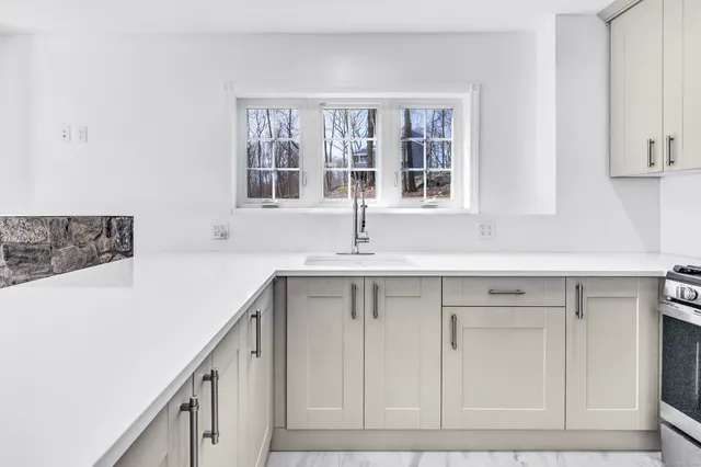 a kitchen with a sink and cabinets