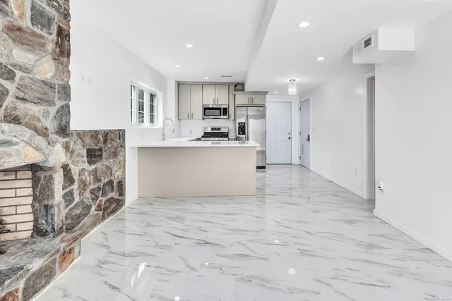 a large white kitchen with white cabinets and a stove