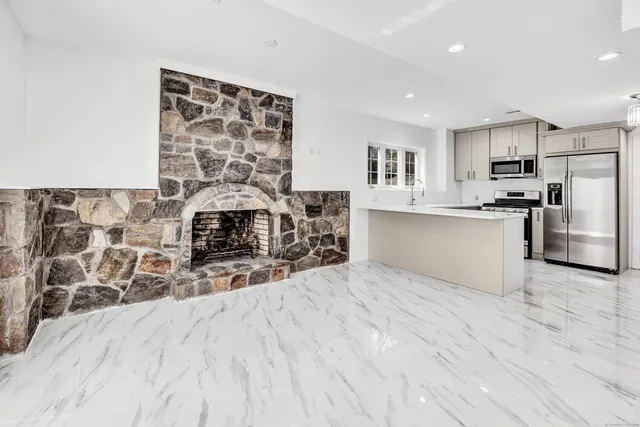 a kitchen with stainless steel appliances a refrigerator and a stove top oven