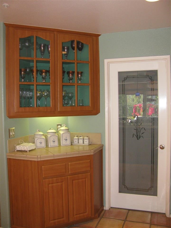 1834 Key Largo Road Vista, CA 92081 - Photo 12 of 25 A delightful corner cabinet perfect for storing your favorite glasses ~ pass through the frosted door to find an interior laundry room! Conveniently located yet discreetly hidden away~~~