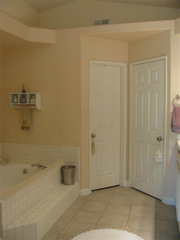 1834 Key Largo Road Vista, CA 92081 - Photo 19 of 25 Sneak peak at spacious Master bathroom offering separate tub, shower, double sinks, walk-in closet~