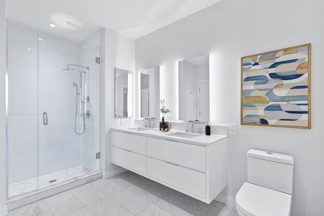 a bathroom with a sink toilet and shower