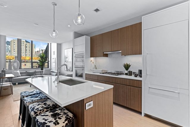 a kitchen with a stove a sink and a refrigerator