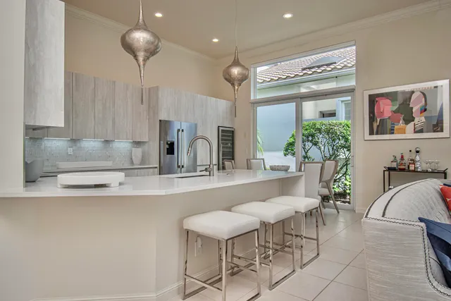 a large kitchen with a large counter top stainless steel appliances and cabinets