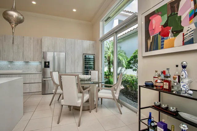 a living room with granite countertop furniture a dining table and a potted plant