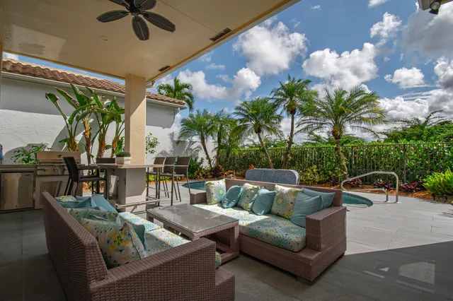 a swimming pool with outdoor seating and yard
