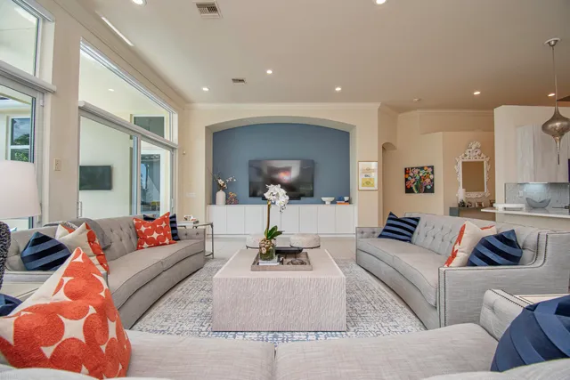 a living room with furniture and a large mirror