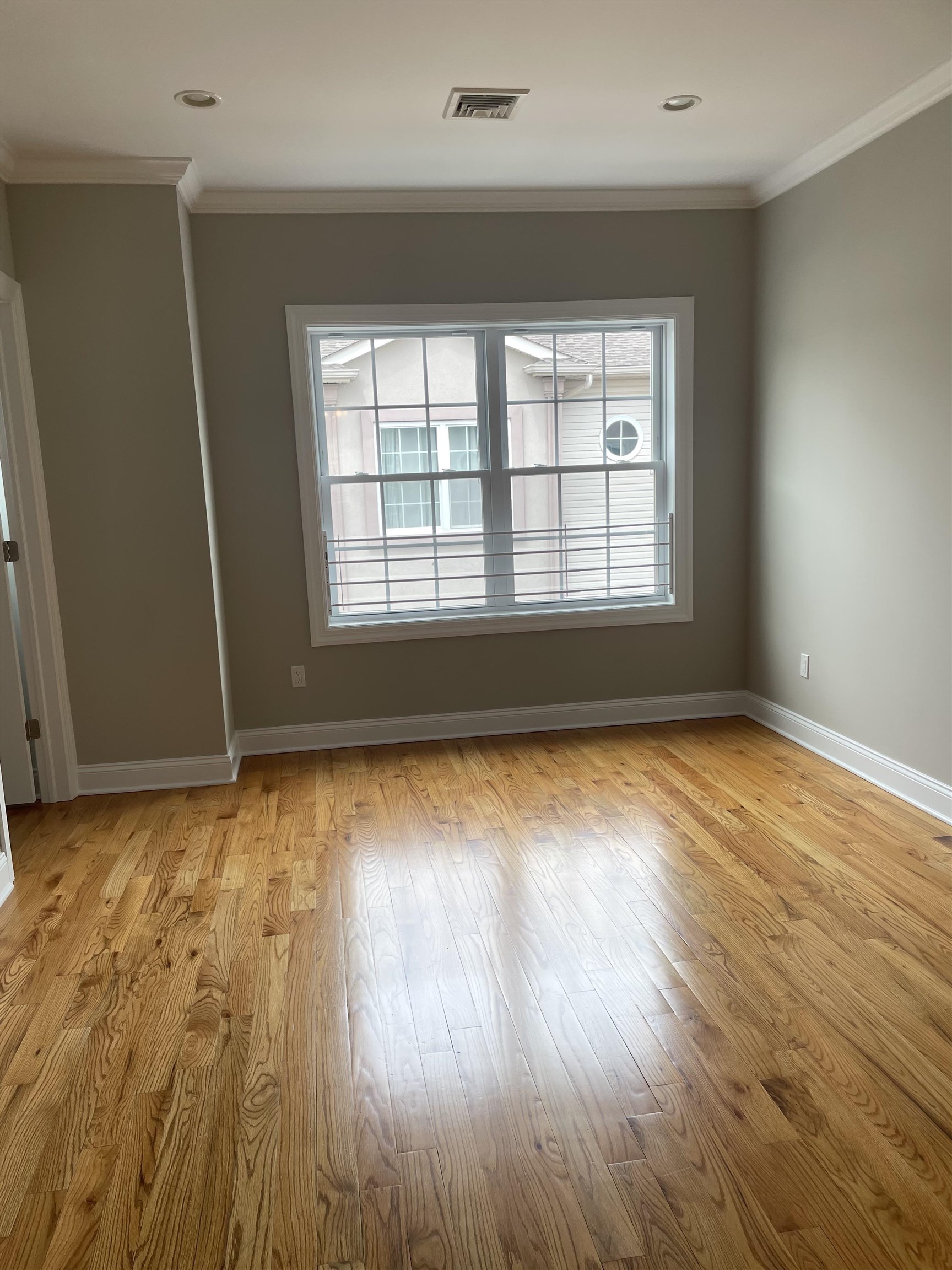 734 County Avenue, Unit A1 Secaucus, NJ 07094 - Photo 13 of 19 an empty room with wooden floor and windows