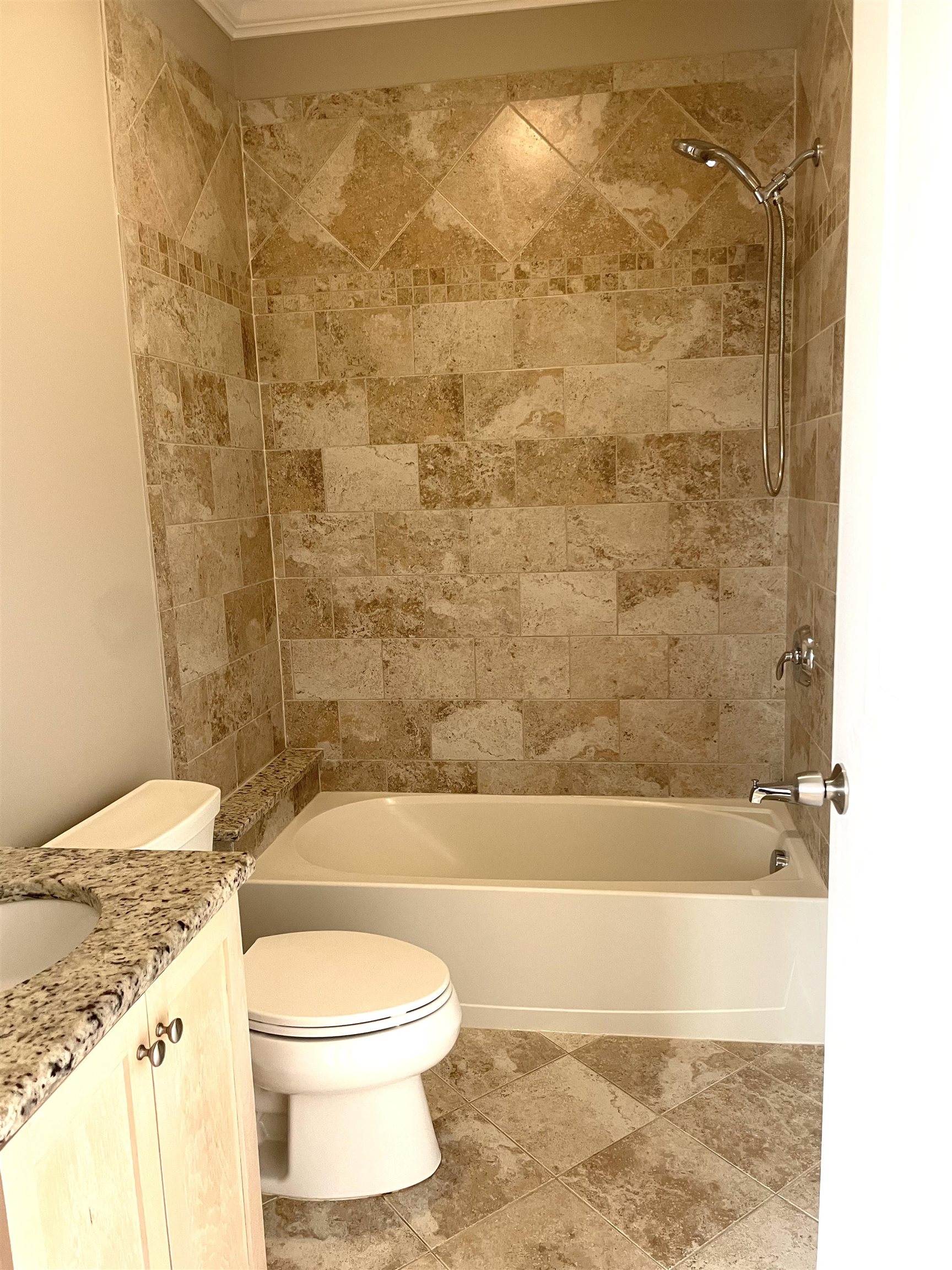 734 County Avenue, Unit A1 Secaucus, NJ 07094 - Photo 16 of 19 a bathroom with a granite countertop toilet a sink and bathtub