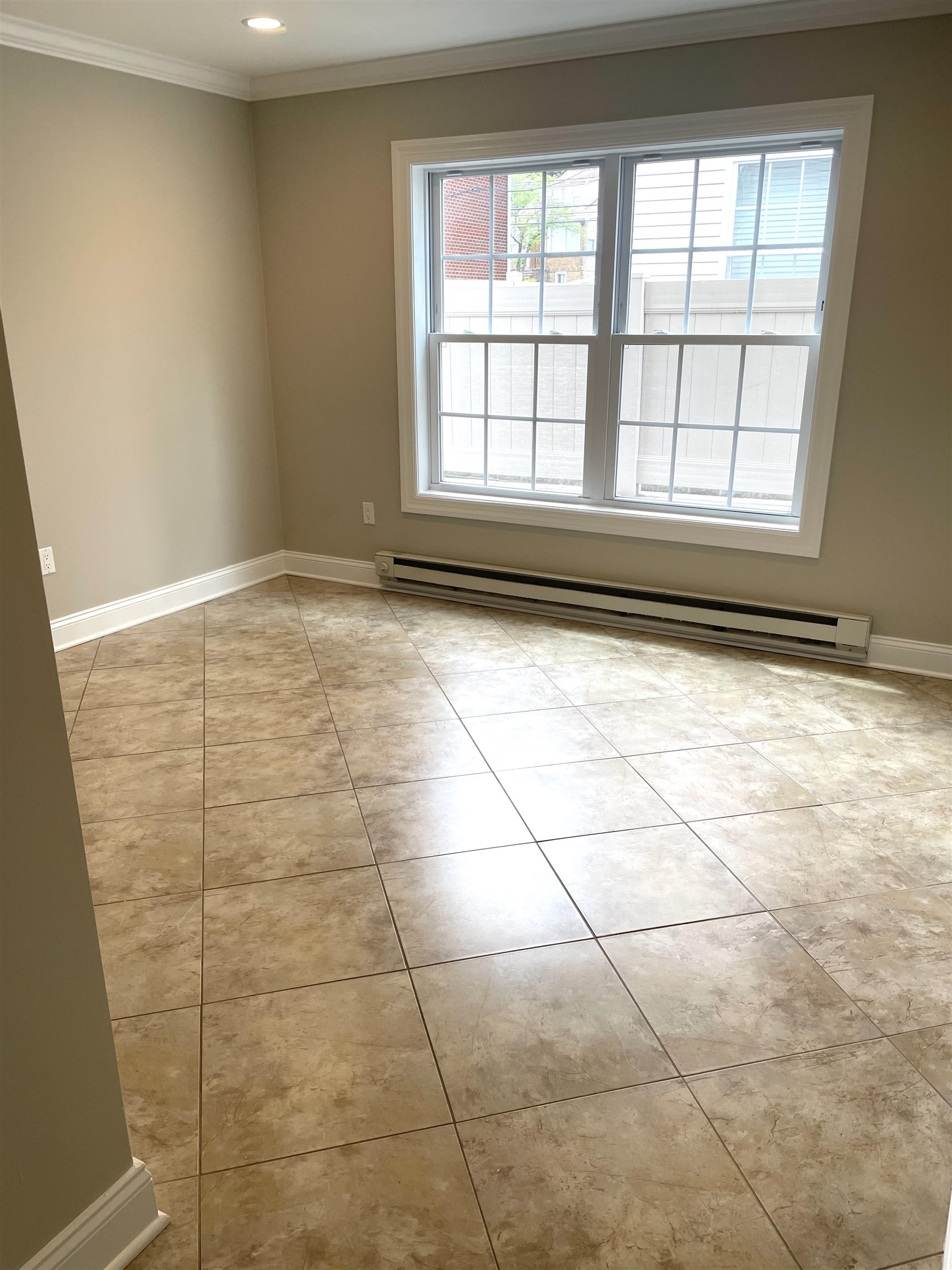 734 County Avenue, Unit A1 Secaucus, NJ 07094 - Photo 17 of 19 a view of a livingroom with an empty space and a window