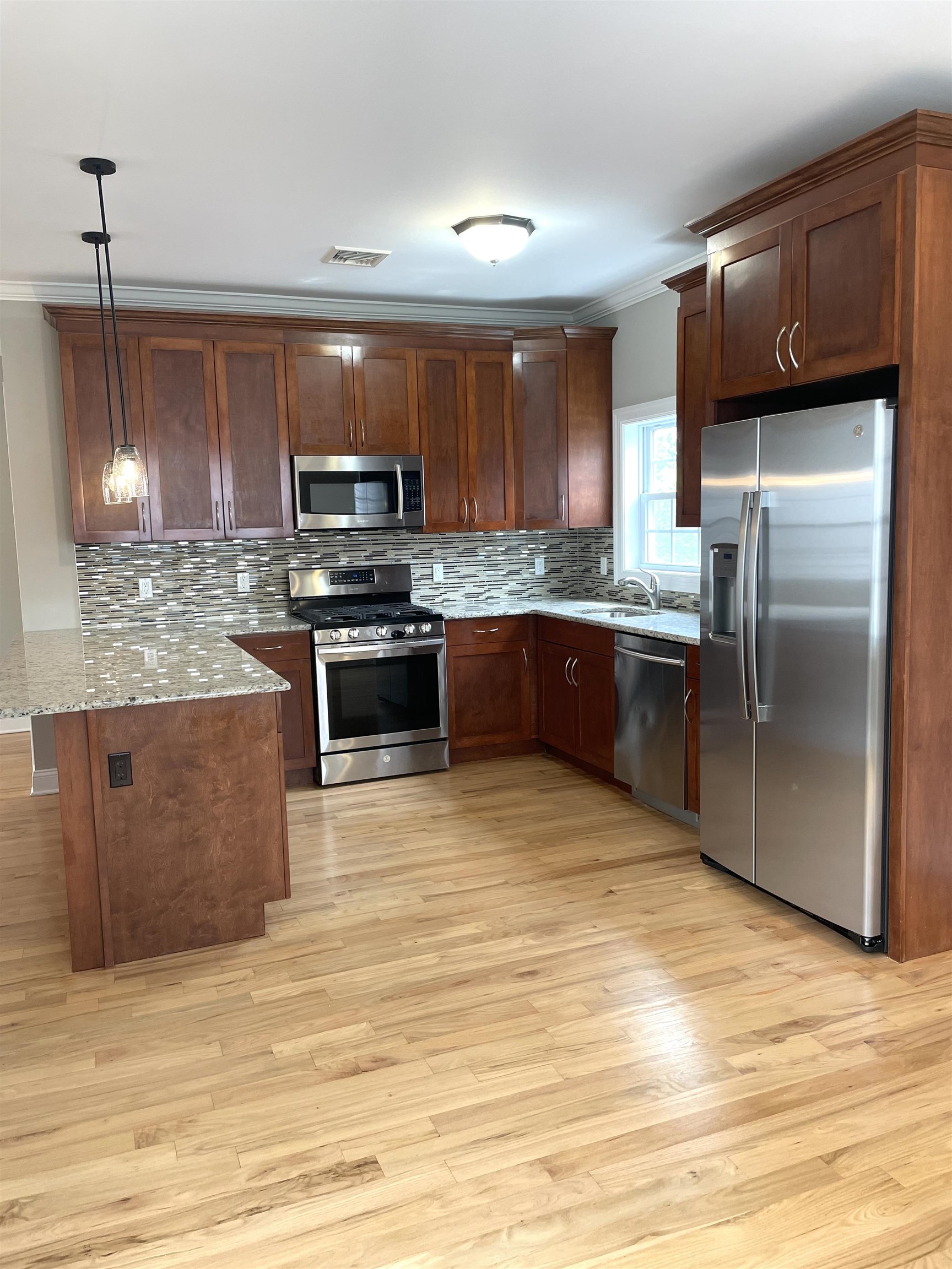 734 County Avenue, Unit A1 Secaucus, NJ 07094 - Photo 4 of 19 a kitchen with stainless steel appliances granite countertop a stove a sink dishwasher and a refrigerator