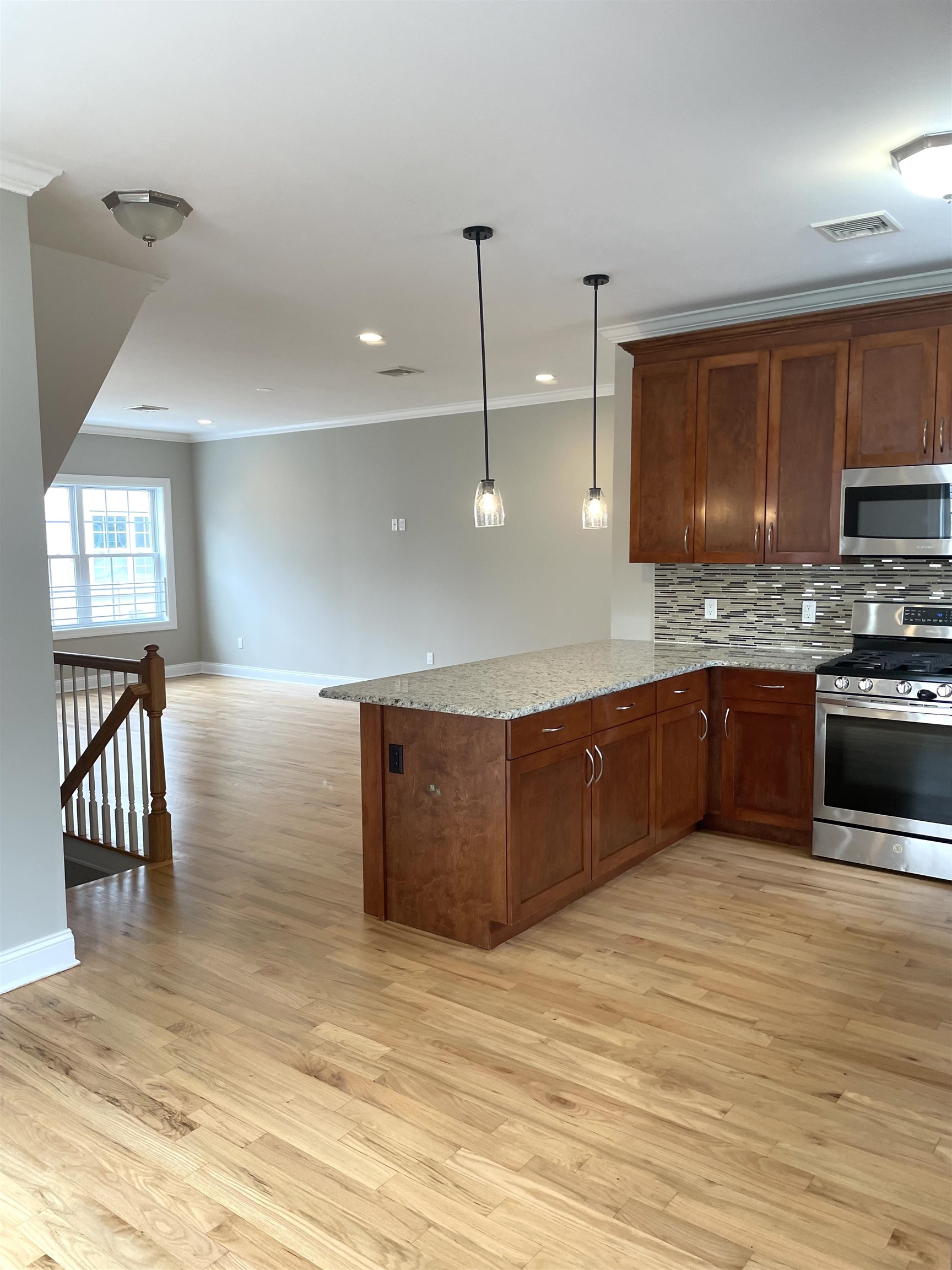 734 County Avenue, Unit A1 Secaucus, NJ 07094 - Photo 5 of 19 a kitchen with stainless steel appliances granite countertop a stove a sink and a refrigerator