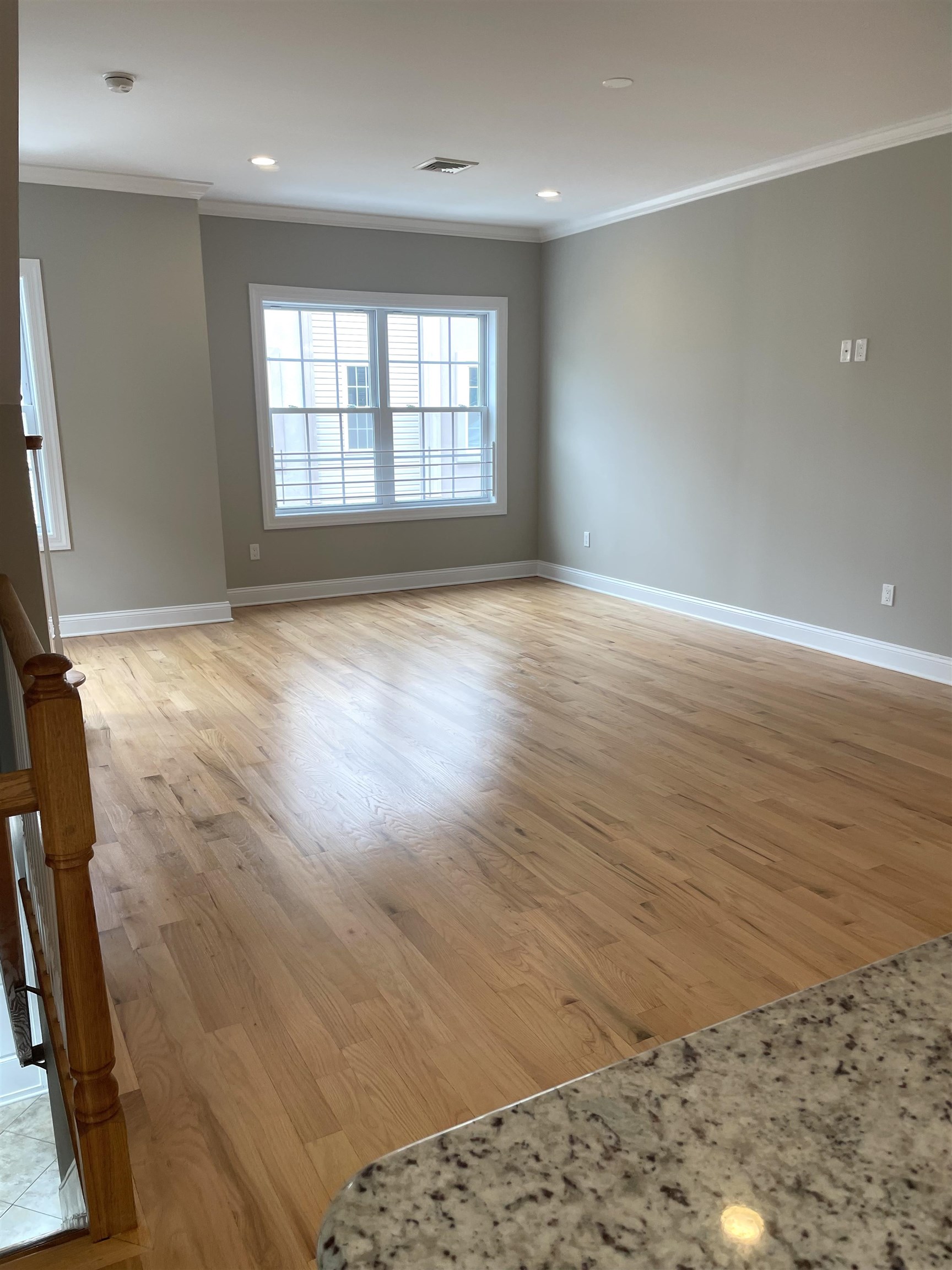 734 County Avenue, Unit A1 Secaucus, NJ 07094 - Photo 6 of 19 an empty room with wooden floor and windows