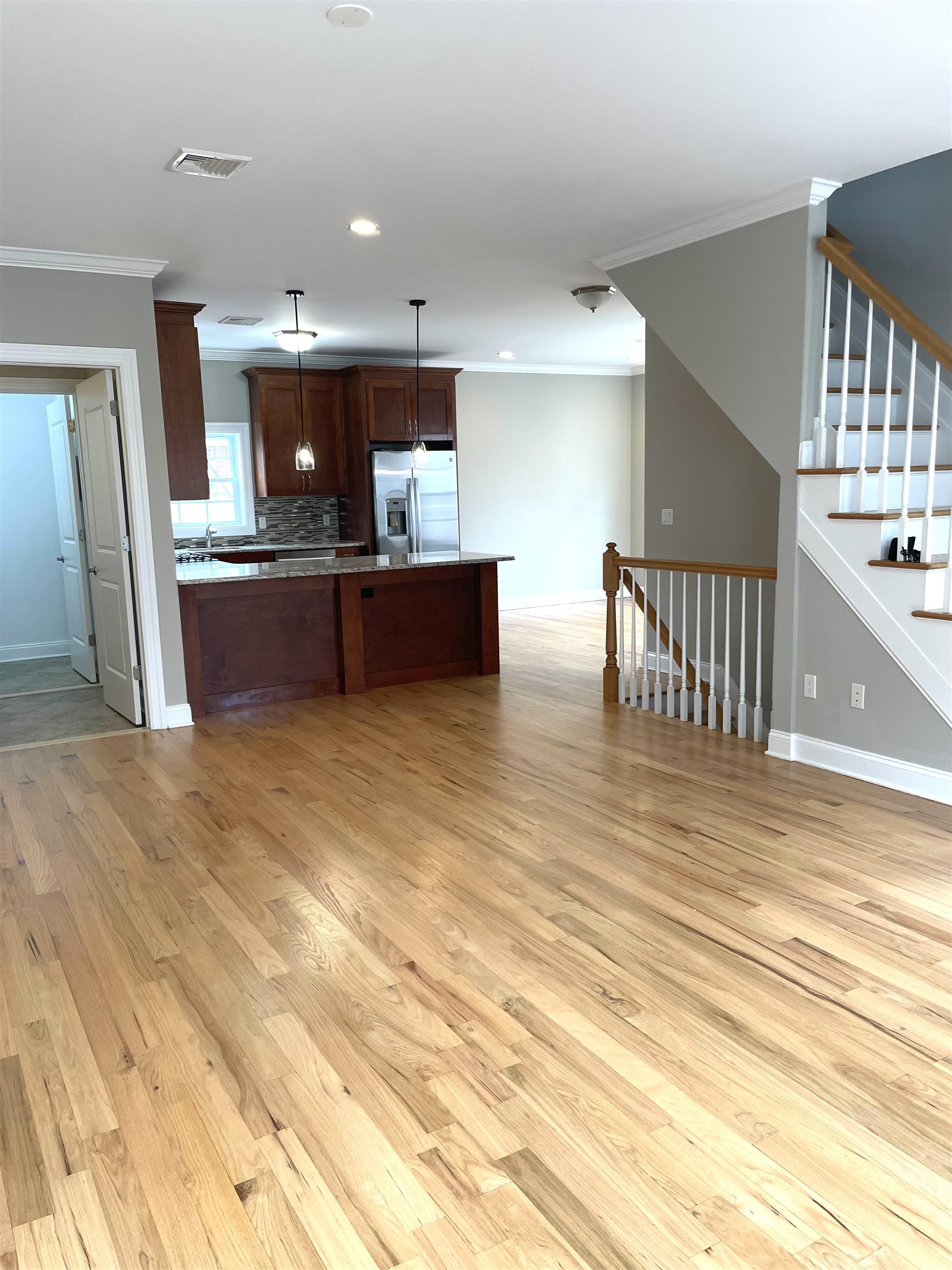 734 County Avenue, Unit A1 Secaucus, NJ 07094 - Photo 7 of 19 a view of a living room and kitchen with furniture and a kitchen