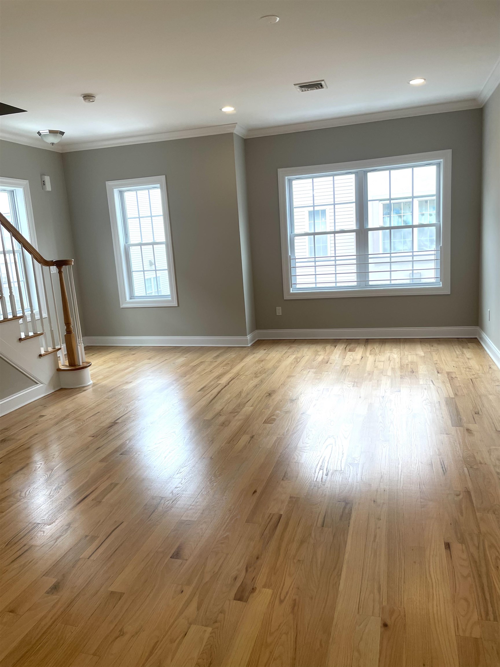 734 County Avenue, Unit A1 Secaucus, NJ 07094 - Photo 8 of 19 an empty room with wooden floor and windows