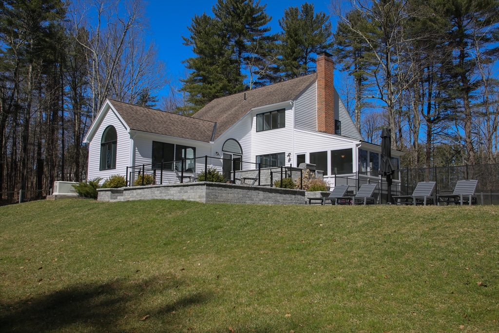 a view of a house with swimming pool and sitting area