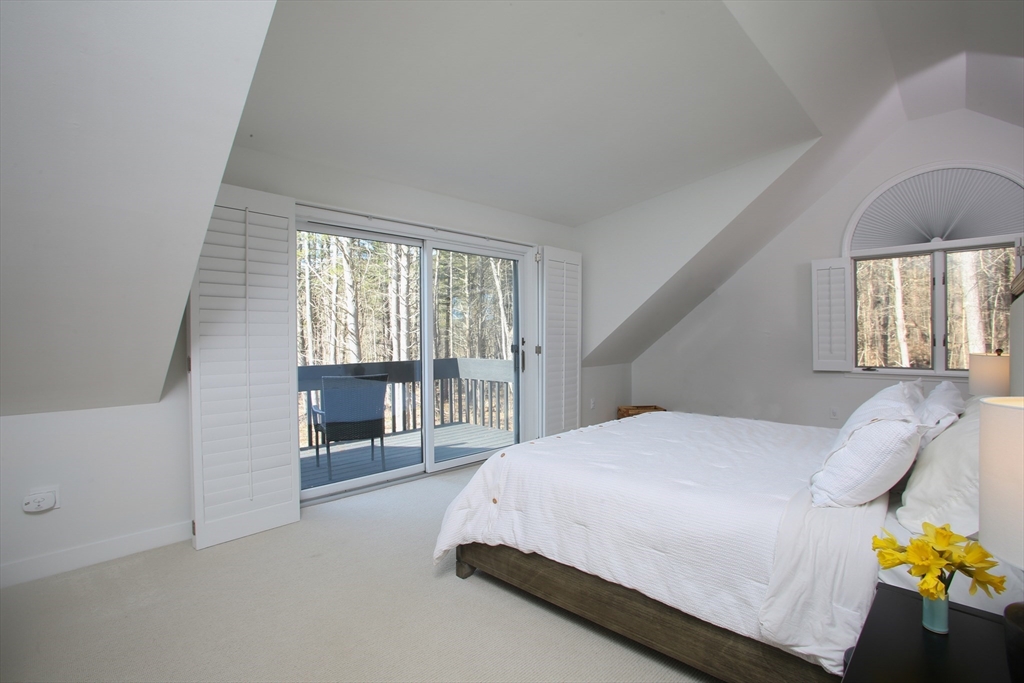 23 Cross Road Alford, MA 01230 - Photo 13 of 37 a spacious bedroom with a bed and glass door