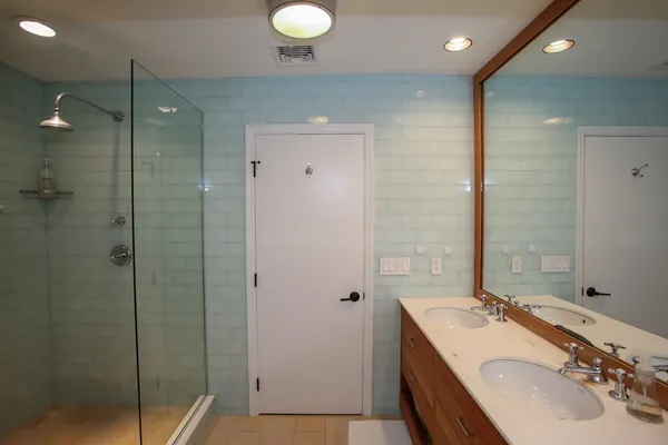 a bathroom with a sink a toilet and a mirror