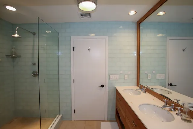 a bathroom with a sink a toilet and a mirror