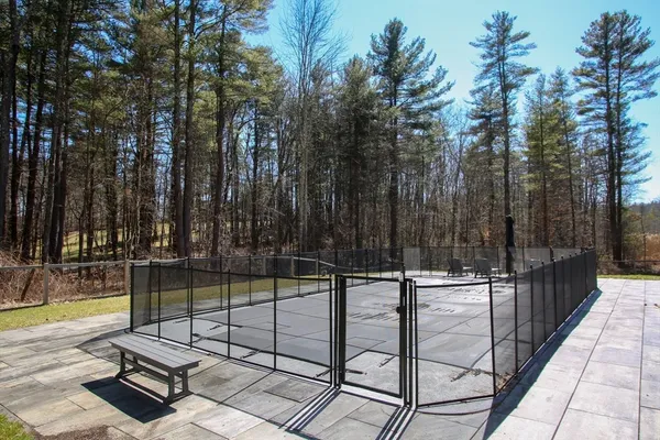 a view of a backyard with swimming pool