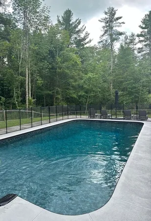 a view of a patio with table and chairs with wooden fence and plants