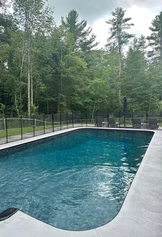 a view of a patio with table and chairs with wooden fence and plants