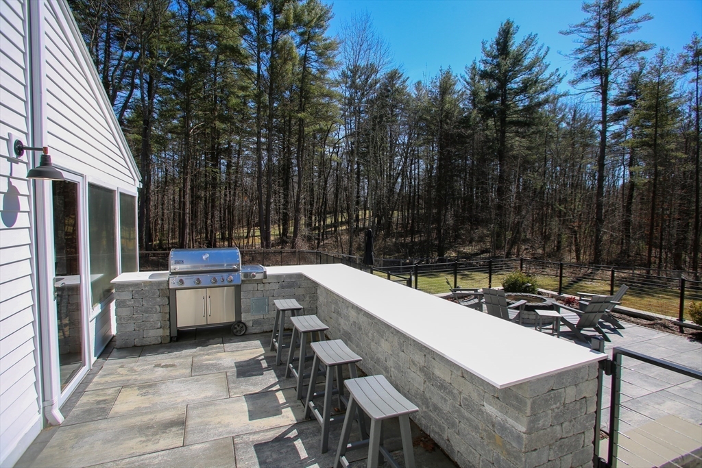 23 Cross Road Alford, MA 01230 - Photo 33 of 37 a view of a patio with table and chairs with wooden fence and plants