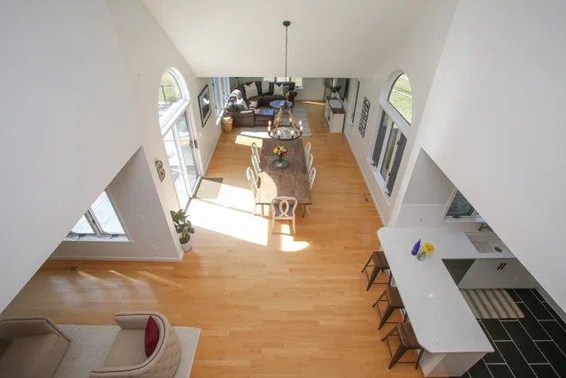 a kitchen with stainless steel appliances a stove a table and chairs
